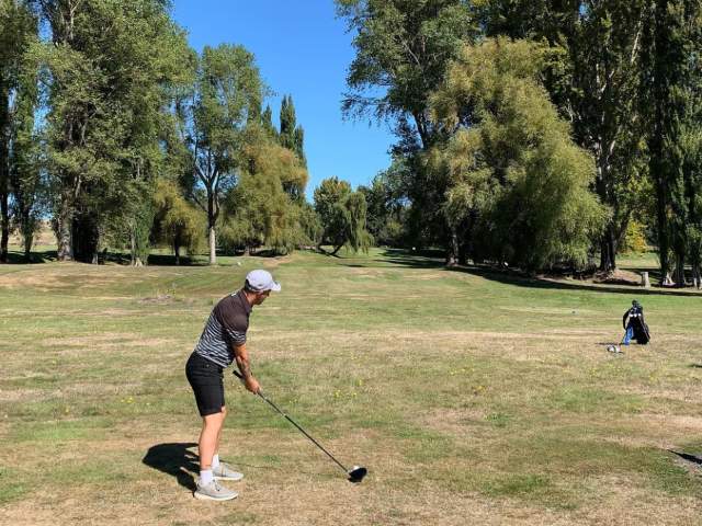 Man teeing off at Kingston Golf Club