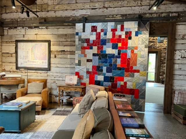 The large sliding door in the lounge made from the wreckage of cars.