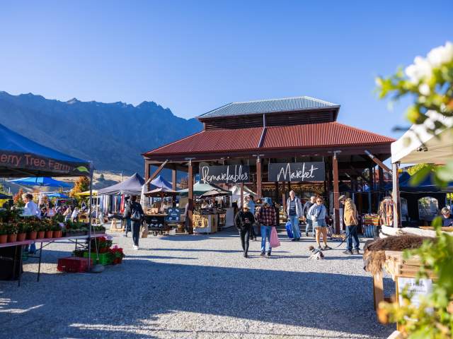 A landscape shot of the iconic Remarkables Market Red Barn on a Saturday morning