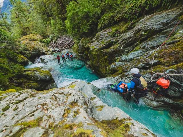 Canyoning the Routeburn, getting ready to slide.