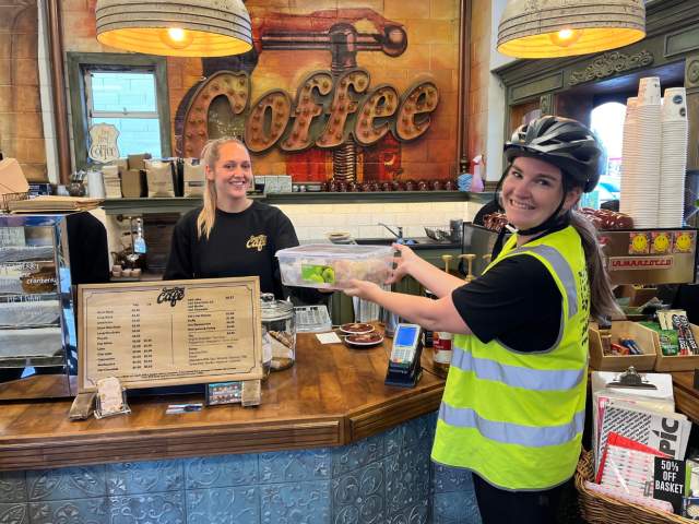 KiwiHarvest volunteer rescuing unsold food from local cafe