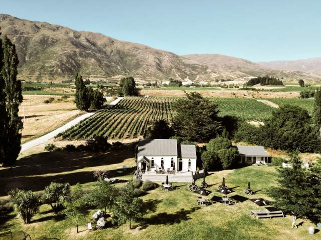 The Church Cellar Door and Cafe in Gibbston on a blue sky day, where The Valley summer music festival will be held in January 2025