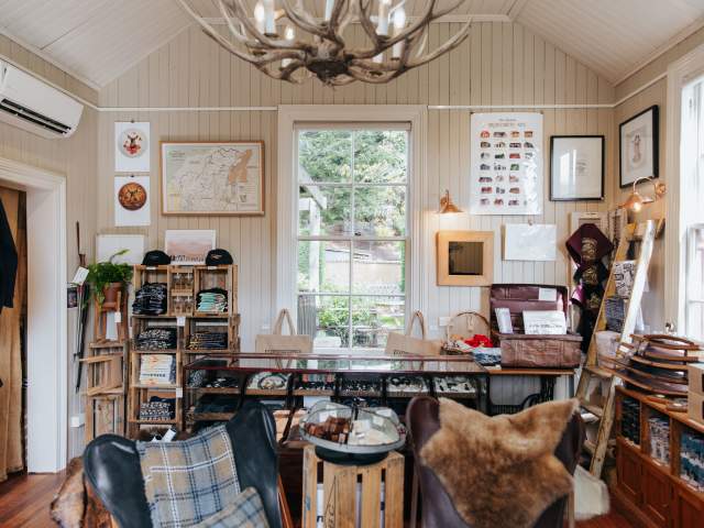 The Old School House in Wānaka featuring local artists' prints and vintage advertising.