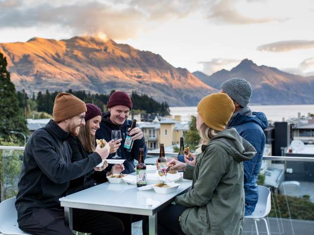 Friends enjoying cold beverages o the balcony at mi-pad