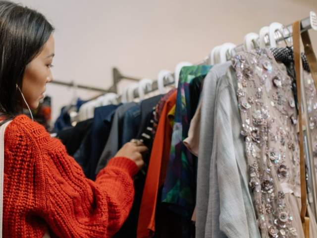 Lady browsing clothes rack