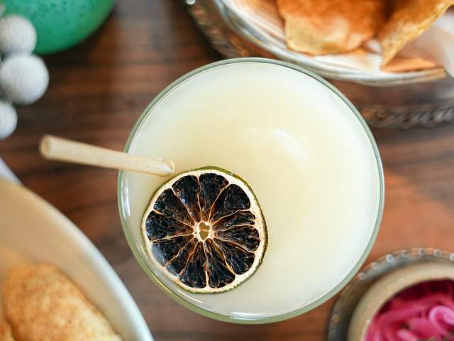 Overhead view of margarita with charred lime on top