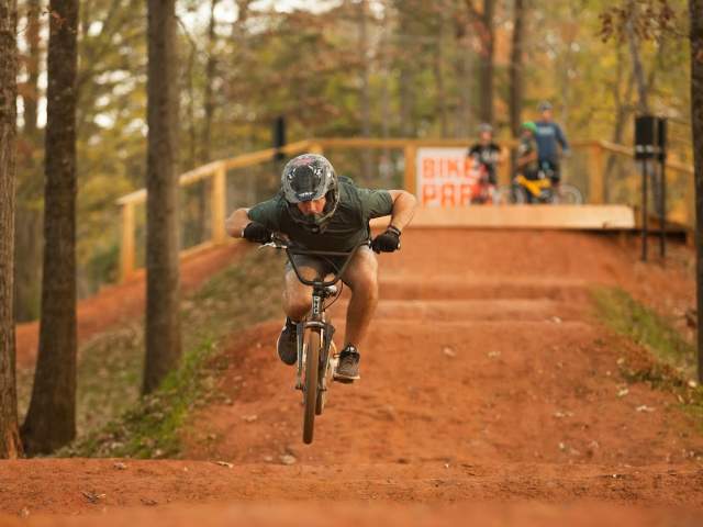Cyclist hitting a dirt jump at the Vic Bailey Bike Park