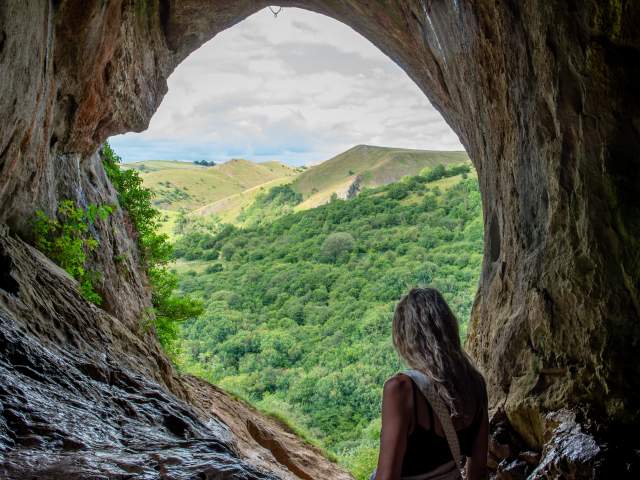 woman looking out from Thor's Cave