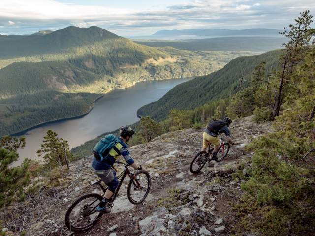 Mountain bikers ride a trail on Mt. Mahony that overlooks Haslam Lake.