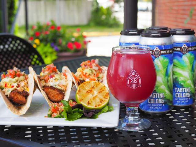 Picture of Rusty Rail Brewery Patio with beer and plate of tasty food on display