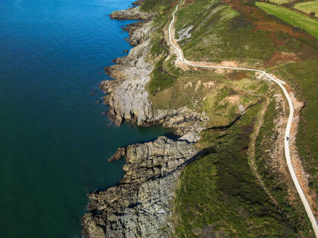 Gower coast path drone overlooking coastal path at cliffs seafront