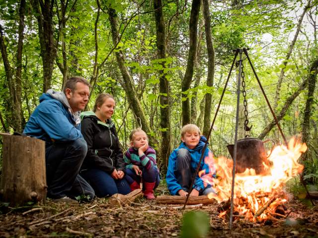 A family participating in a bushcraft activity