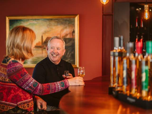 A man and woman enjoying a whiskey tour in Penderyn, Swansea