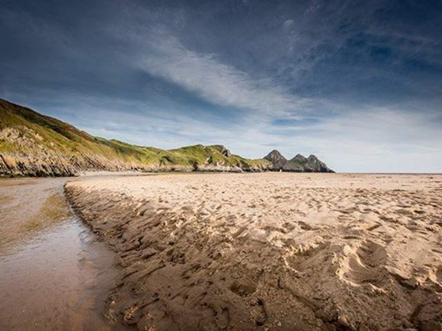 photo of beach with coast in background