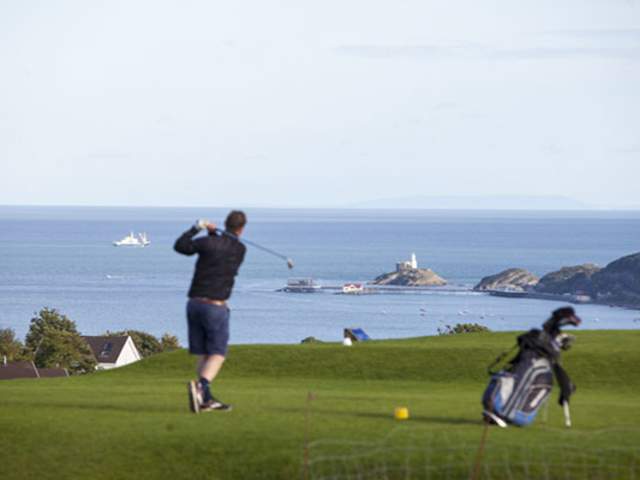 A man playing golf.