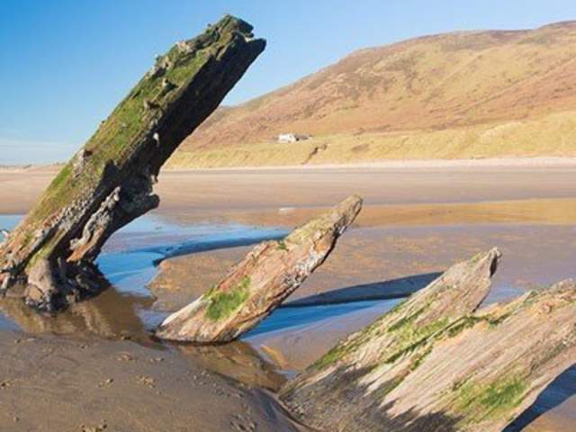 wreckage of the Helvetica shipwreck sticking out of the beach in Rhossili