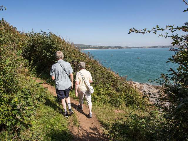 Older couple walking on the coastal path at Oxwich.