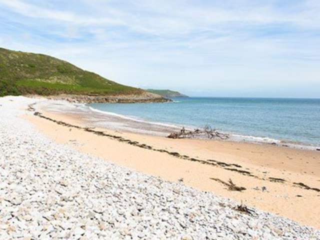 tide coming in against the beach in Pwll Du