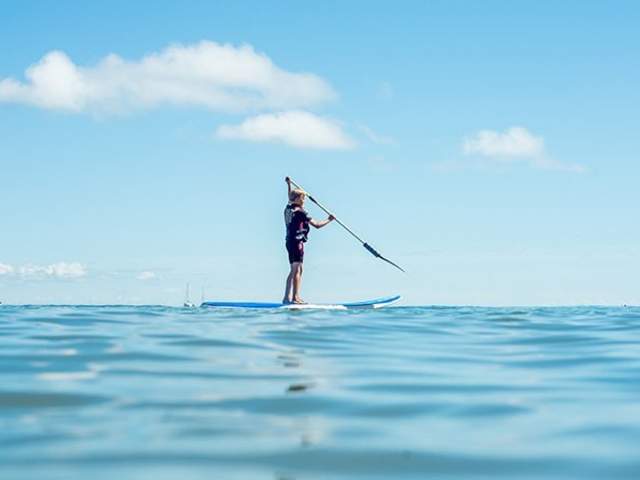 A person taking part in the Gower Stand up Paddle activities