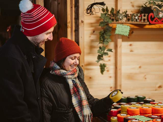 A couple looking at cheese at the Christmas Market