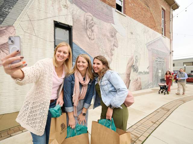 Group Photo in front of 'Reflections from Time' Mural