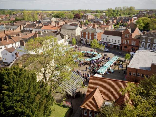 an aerial view of Market Rasen market with stalls and trees in foreground