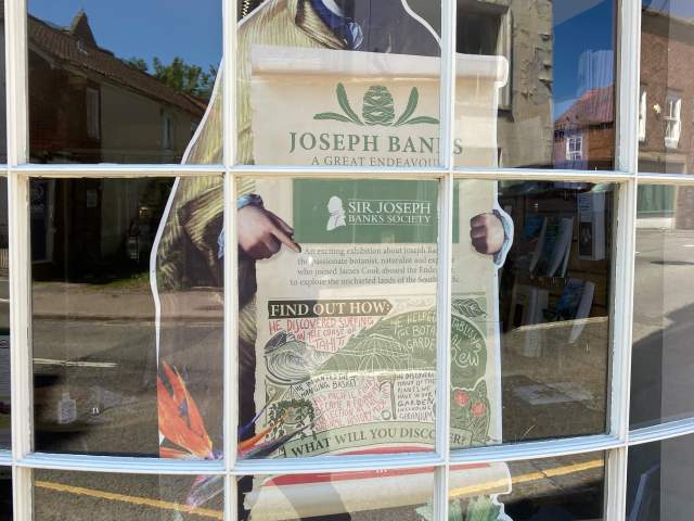 a cut out of Sir Joseph Banks inside a window of a visitors centre