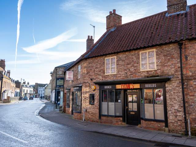 a street in horncastle with historic houses and restaurant in the foreground