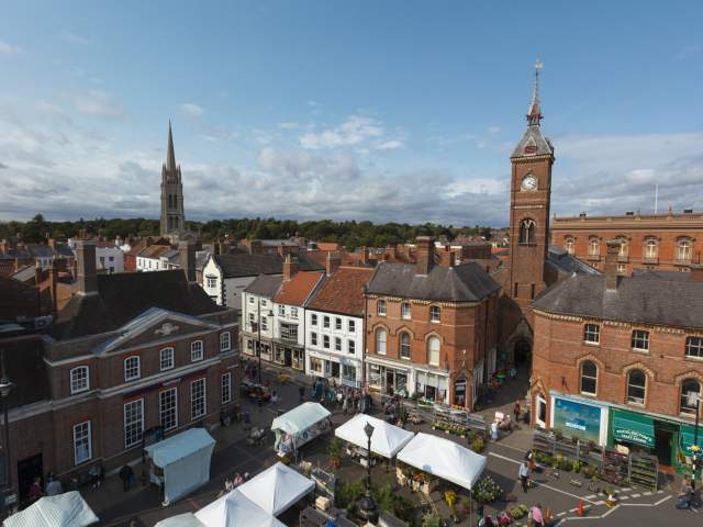 a skyline of Louth with market square below and church in background under blue skies