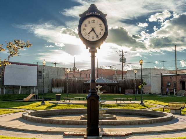 Historic downtown Rawlins, Wyoming, featuring brick buildings and a quiet park.