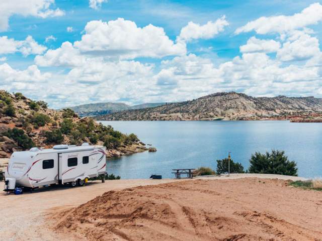 Serene waters of Alcova Reservoir surrounded by rocky cliffs in Natrona County, Wyoming.