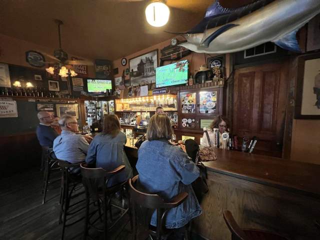 Patrons enjoying a drink at the bar.