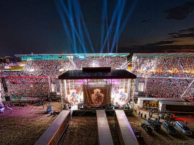 A top event in Wyoming, crowd gathers in an outdoor arena for a concert at the Cheyenne Frontier Days Rodeo.