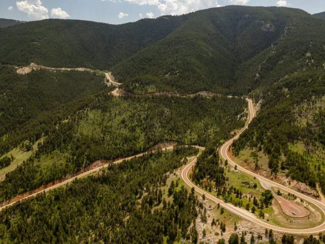 A winding road carving its way through Bighorn National Forest in Wyoming.