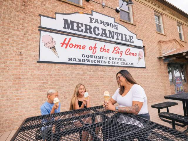 Exterior building of Farson Mercantile with family enjoying ice cream at picnic tables.