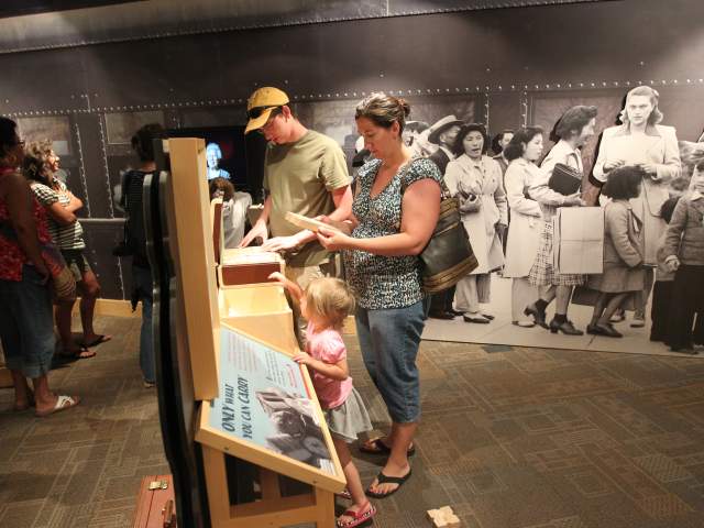 Family browsing exhibit at Heart Mountain Interpretive Center
