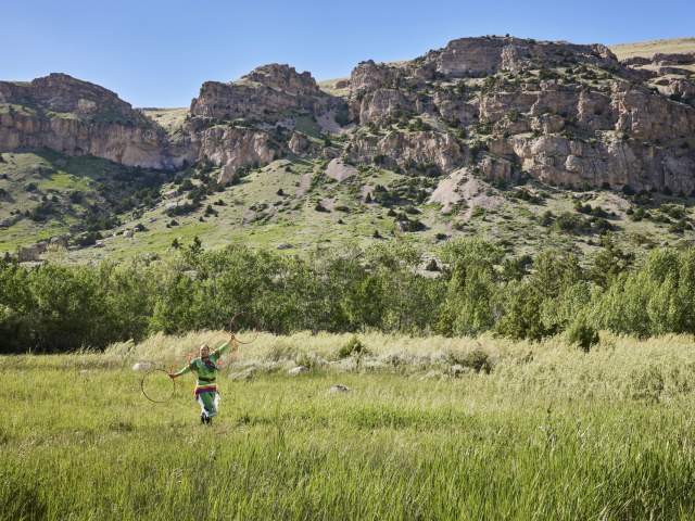 Hoop dancer in a field in Wind River country.