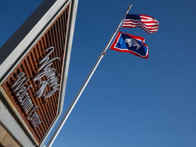 Welcome Center Sign with the American and Wyoming flags