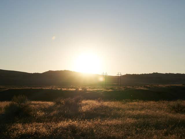 Sunset light glows over Wyoming’s lush, open terrain.
