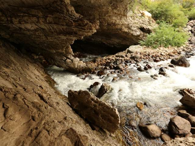 River running through a cave at Sinks Canyon State Park, a Wyoming landmark.