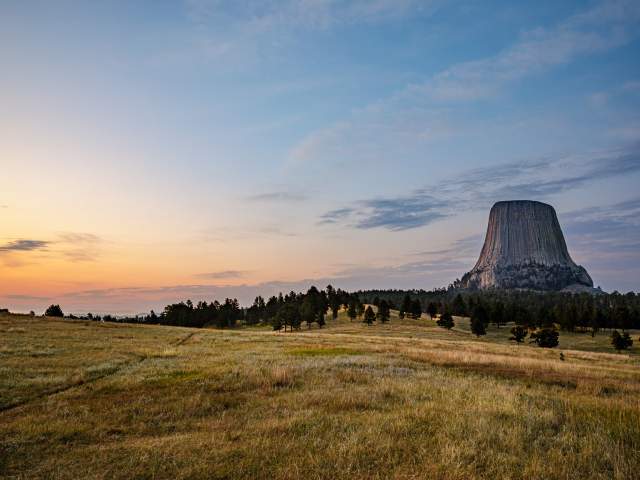 Devils Tower against a sunset sky