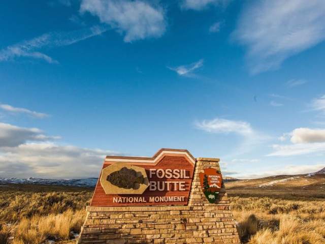 A blue sky with wispy clouds overlooks the Fossil Butte National Monument in Lincoln County, Wyoming.Butt