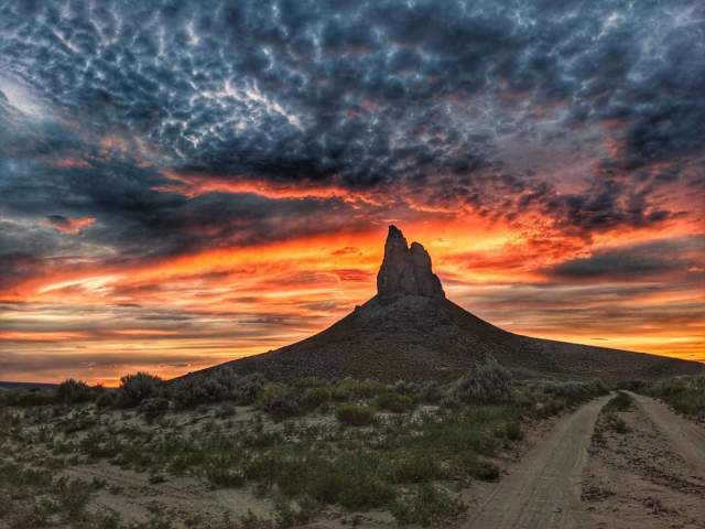 Vibrant sunset at Boar's Tusk, a geologically formed landmark in Wyoming.