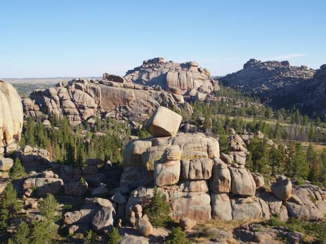 A view of the various large rock formations nestled within a forest of trees at the Vedauwoo Recreation Area.