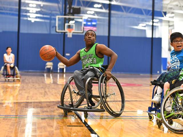 man playing wheelchair basketball