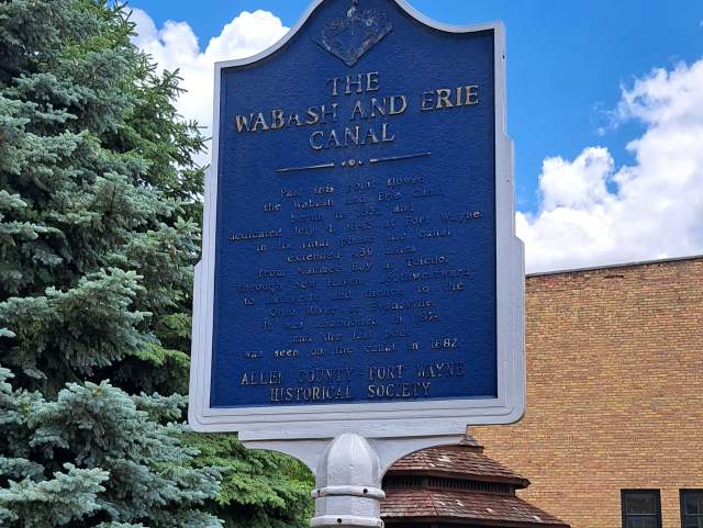 Blue, patinaed commemorative plaque at New Haven Canal Landing Park that says, "The Wabash and Erie Canal"