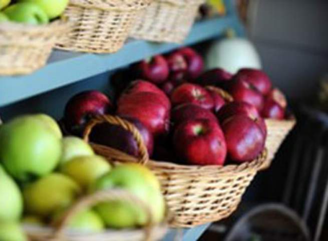 Green and red apples in baskets