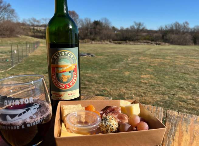 Wine poured in a glass with charcuterie