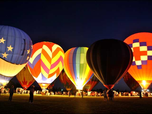 Colorful hot air balloons soaring at Bluff Balloon Festival 2025