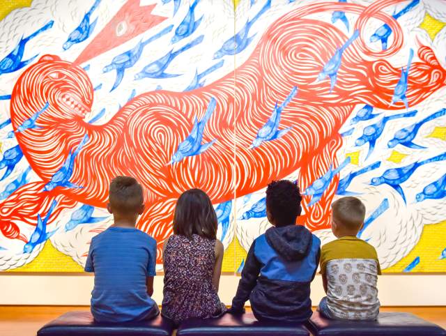 children looking up at a painting in the fort wayne museum of art